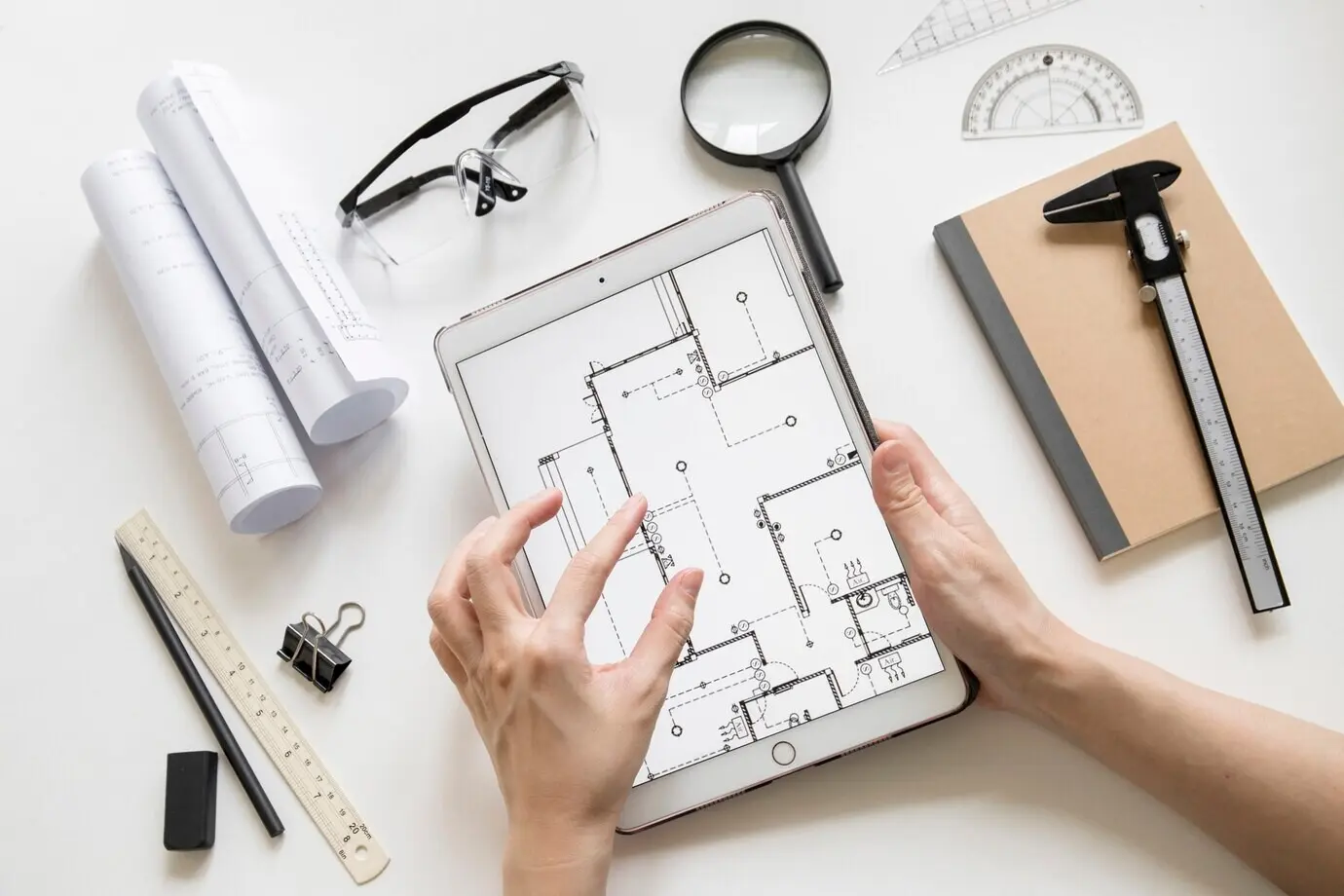 Cropped view of hands zooming in on a draft on a tablet.